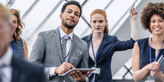 Businesswoman at a Business Event Raising Hands